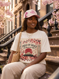 Blossom Tee editorial - model in cream tee with Now Faith Is hat