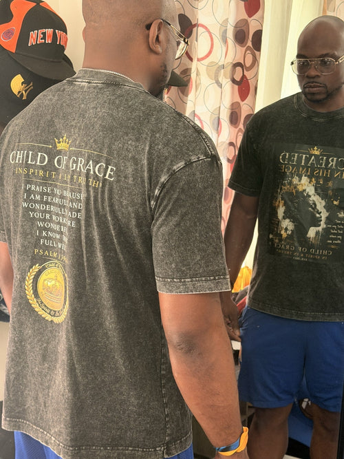 Jason wearing the Created In His Image tee, showing the front in the mirror