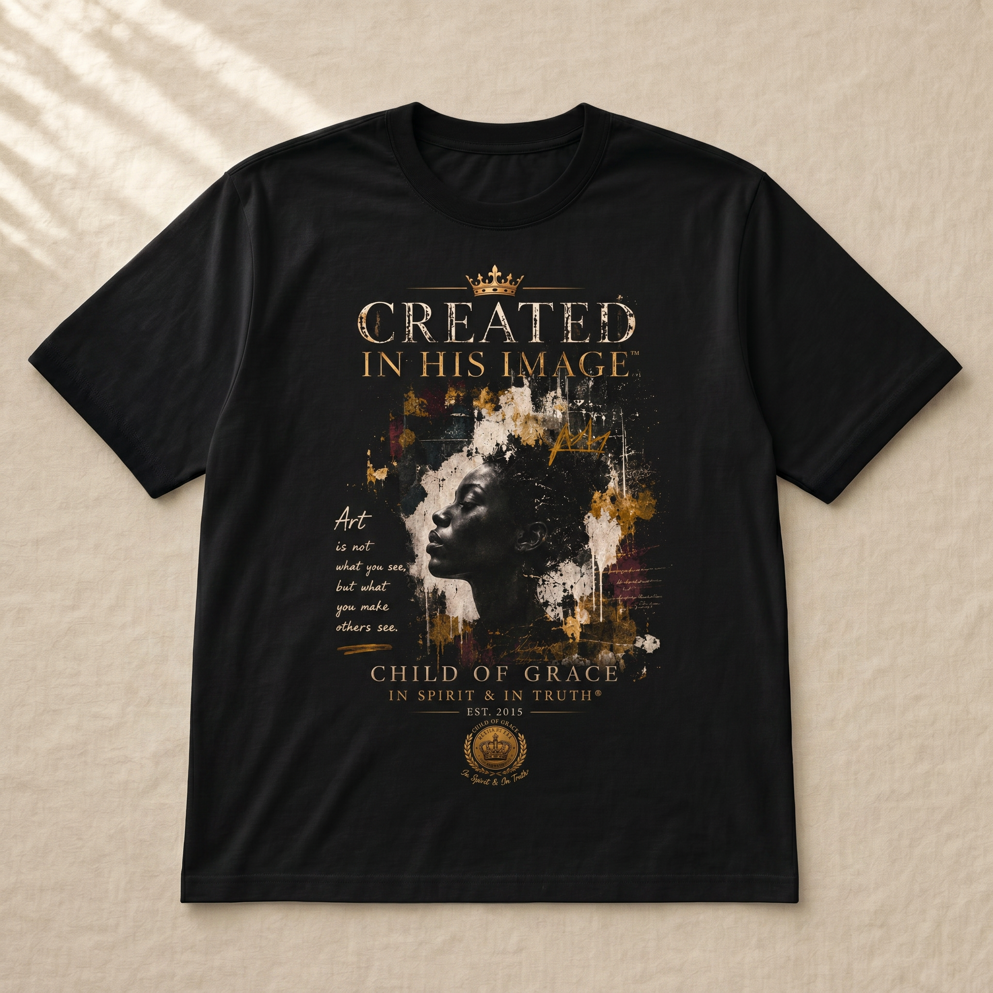 Created In His Image™ Tee — Flat-lay on cream linen