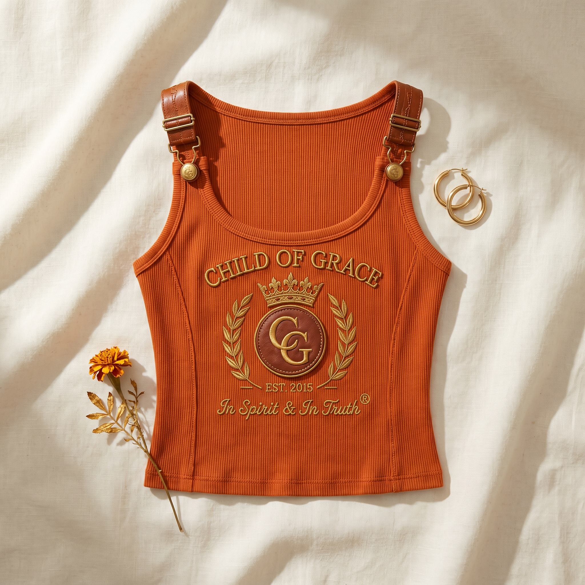Child Of Grace Crest Buckle-Strap Tank — Rust Orange flatlay on linen